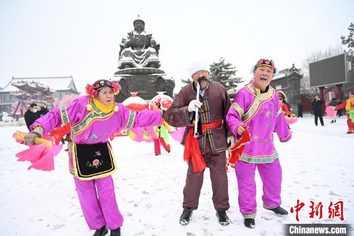 2月13日，秧歌隊在呼和浩特市大召廣場雪中起舞?！⑽娜A 攝