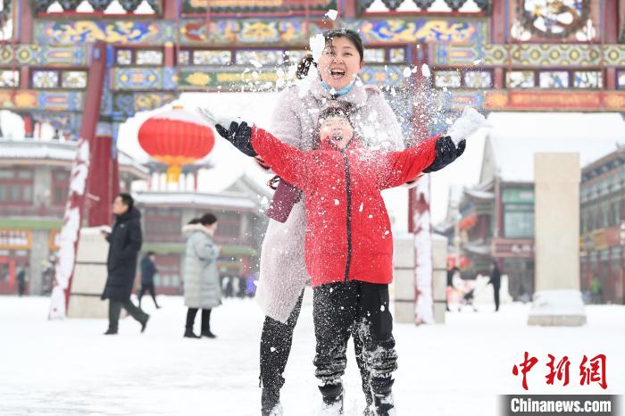 2月13日，家長與小朋友在呼和浩特市大召廣場享雪趣?！⑽娜A 攝