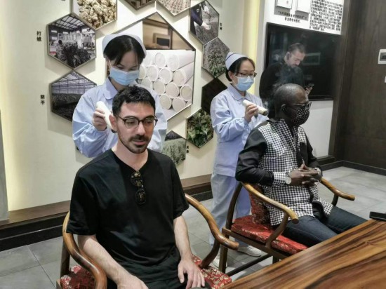 2023“一帶一路”媒體合作論壇聯(lián)合采訪(fǎng)團(tuán)團(tuán)員在九牛草展示館體驗(yàn)艾灸。（本報(bào)記者 黃超攝）