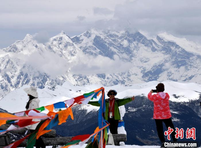 圖為5月14日，西藏林芝色季拉山觀景臺(tái)，游客與南迦巴瓦峰合影?！±盍?攝