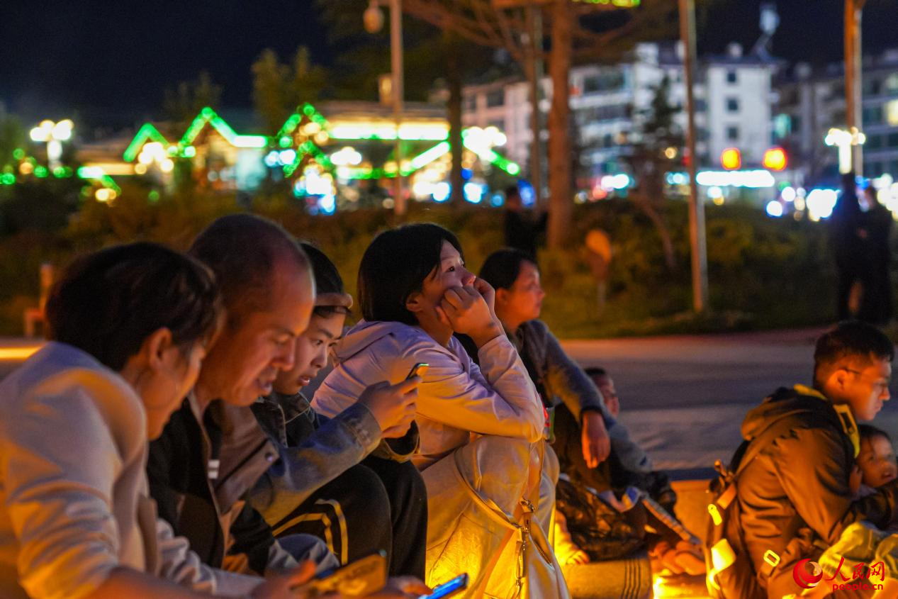 市民坐在西藏林芝市民族團(tuán)結(jié)廣場(chǎng)臺(tái)階上欣賞音樂噴泉。人民網(wǎng)記者 趙晨攝